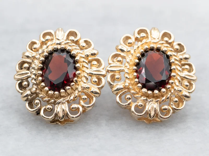 Stud Earrings with Abstract Designs -Yellow Gold Oval Cut Garnet Stud Earrings with Scrolling Frame