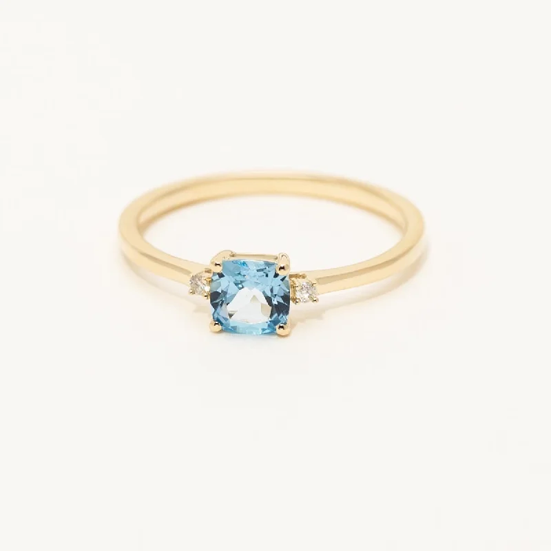 Women’s gold rings with shimmering opal centerpieces -Cushion Cut Swiss Blue Topaz Ring in 10kt Yellow Gold with Diamonds (.02ct tw)