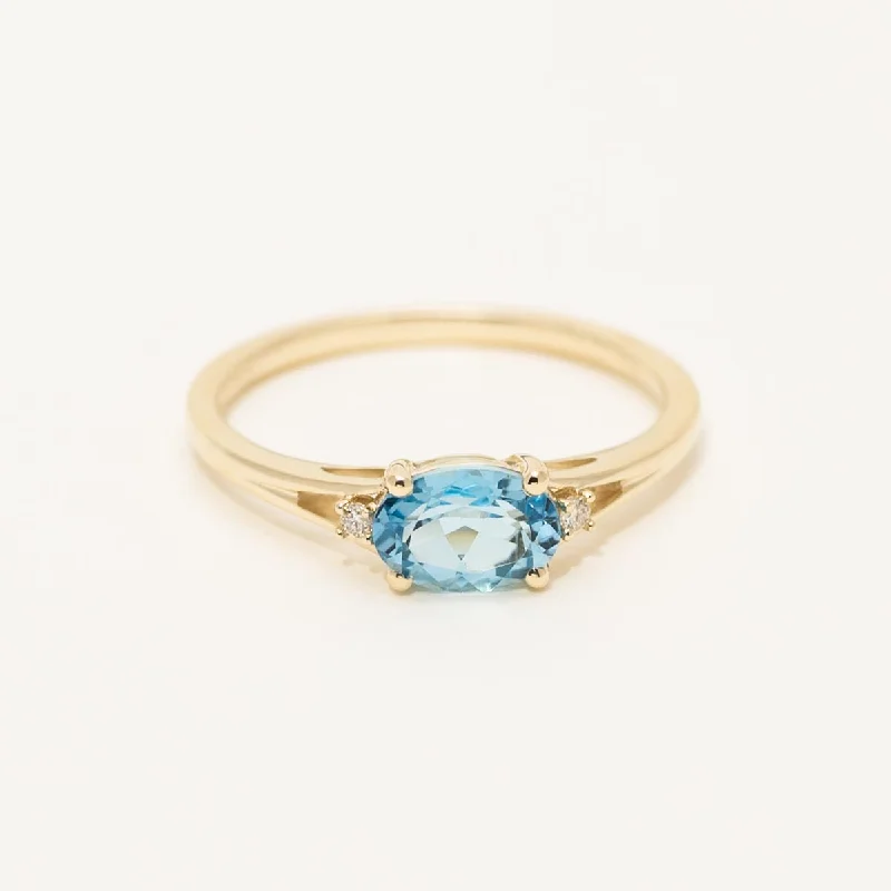 Women’s rings with peridot stones for sparkle -Oval Swiss Blue Topaz Ring in 10kt Yellow Gold with Diamonds (.02ct tw)